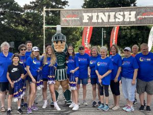 Sparty and volunteers at the finish line of Max's Race