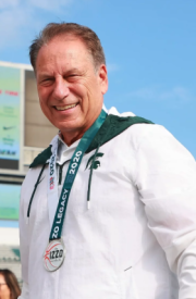 Tom Izzo, outside of Spartan Stadium, wearing a Izzo Legacy Race Finshers Medal.