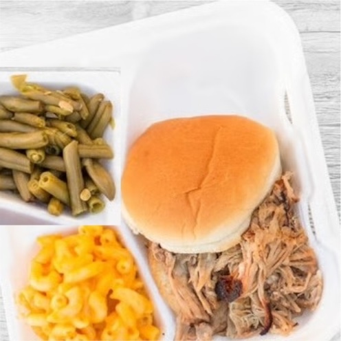 BBQ sandwich with mac & cheese and green beans in a takeout container
